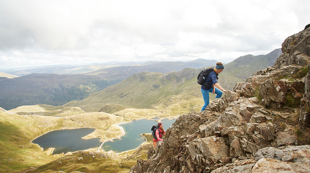 Two females hiking together in mountainous terrain, Mt. Snowdon, North Wales